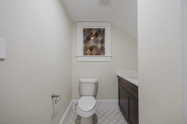 5532 Reiger Ave, Dallas, TX 75214 - half bathroom with vanity, toilet, baseboards, a textured wall, and vaulted ceiling