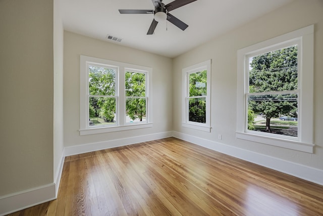 5532 Reiger Ave, Dallas, TX 75214 - empty room with plenty of natural light, baseboards, and light wood finished floors
