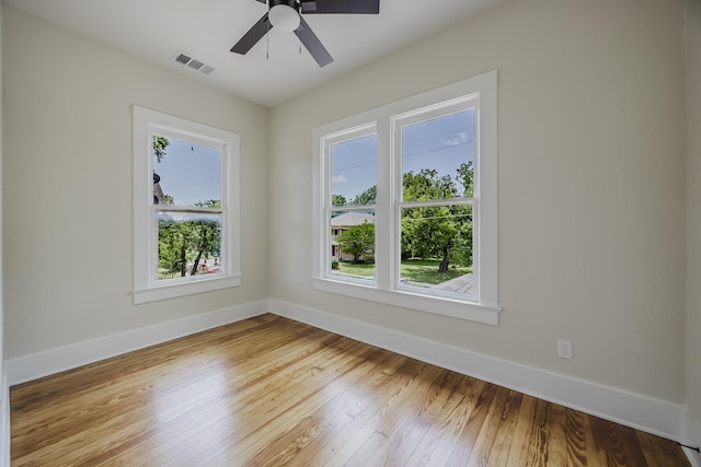 5532 Reiger Ave, Dallas, TX 75214 - empty room featuring plenty of natural light, baseboards, wood finished floors, and ceiling fan