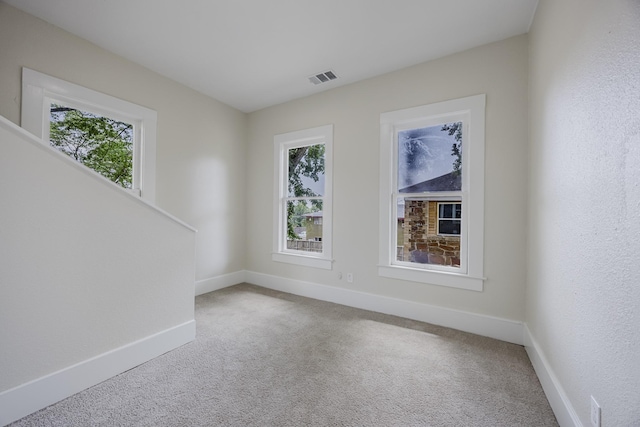 5532 Reiger Ave, Dallas, TX 75214 - carpeted spare room featuring healthy amount of natural light, baseboards, and stairway