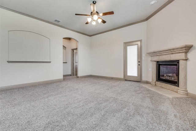 3009 Guadalupe Dr, Forney, TX 75126 - unfurnished living room with ornamental molding, a high end fireplace, carpet, arched walkways, and ceiling fan