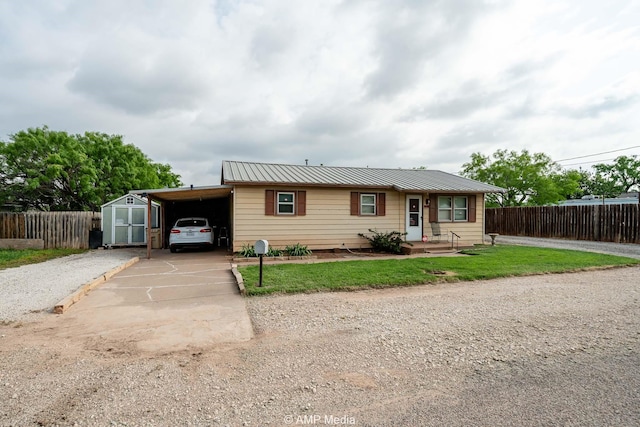 1302 6th St, Anson, TX 79501 - view of front of home with metal roof, concrete driveway, and a carport