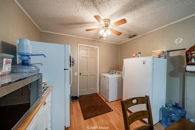 1302 6th St, Anson, TX 79501 - washroom with washer / dryer, crown molding, a ceiling fan, light wood-style floors, and a textured ceiling
