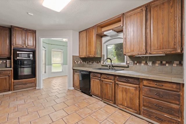 124 Bent Tree Trl, Burleson, TX 76028 - kitchen with black appliances, a sink, tasteful backsplash, light countertops, and a textured ceiling