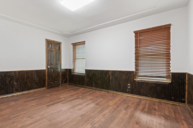 124 Bent Tree Trl, Burleson, TX 76028 - empty room featuring a wainscoted wall, wood finished floors, and wooden walls