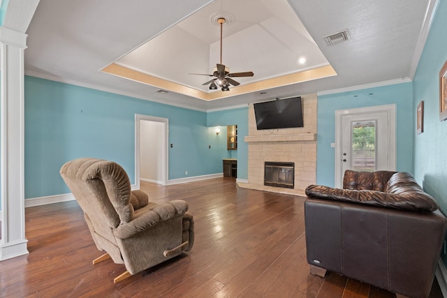 124 Bent Tree Trl, Burleson, TX 76028 - living area featuring a raised ceiling, a fireplace, a ceiling fan, hardwood / wood-style flooring, and baseboards
