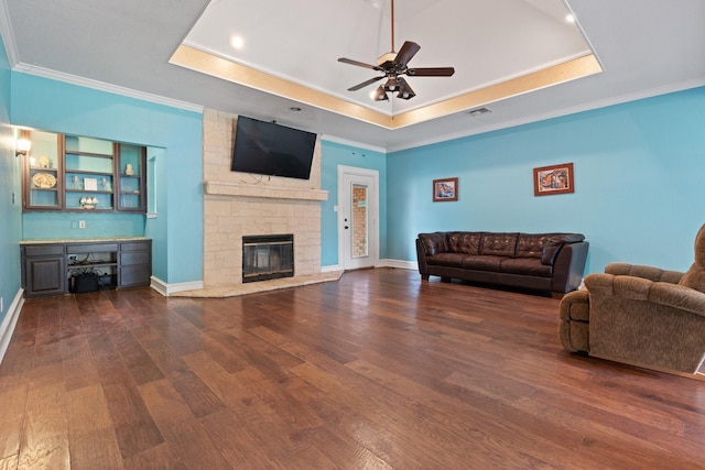 124 Bent Tree Trl, Burleson, TX 76028 - living room featuring a tray ceiling, hardwood / wood-style floors, crown molding, ceiling fan, and a fireplace