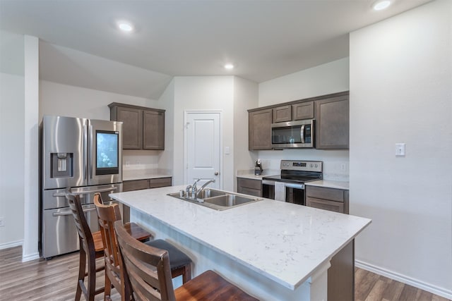 117 Sir Barton Ln, Caddo Mills, TX 75135 - kitchen featuring appliances with stainless steel finishes, a sink, dark brown cabinetry, wood finished floors, and recessed lighting