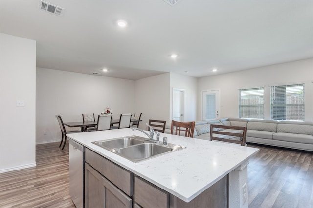 117 Sir Barton Ln, Caddo Mills, TX 75135 - kitchen with dishwasher, a sink, open floor plan, light wood-type flooring, and recessed lighting