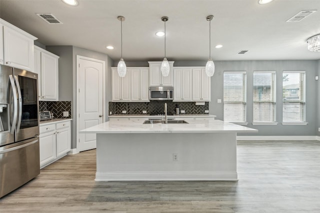 716 Field Xing, Little Elm, TX 76227 - kitchen with appliances with stainless steel finishes, recessed lighting, white cabinetry, light wood-style floors, and baseboards