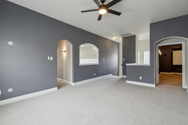 716 Field Xing, Little Elm, TX 76227 - spare room featuring a ceiling fan, light carpet, arched walkways, and baseboards