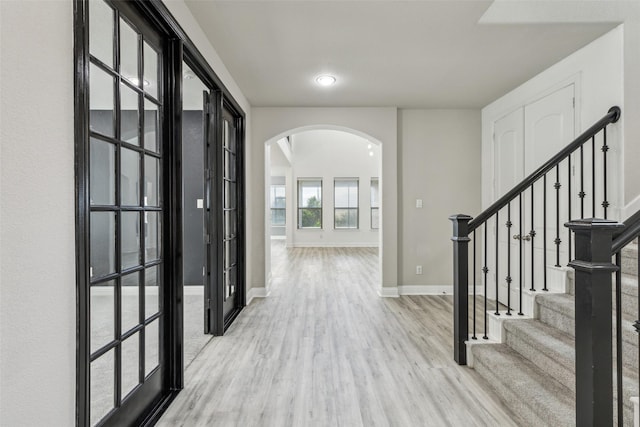 716 Field Xing, Little Elm, TX 76227 - hall featuring arched walkways, wood finished floors, baseboards, stairway, and recessed lighting