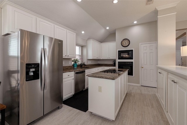 7951 Belladonna Dr, Fort Worth, TX 76123 - kitchen with black appliances, white cabinetry, a center island, light wood finished floors, and lofted ceiling