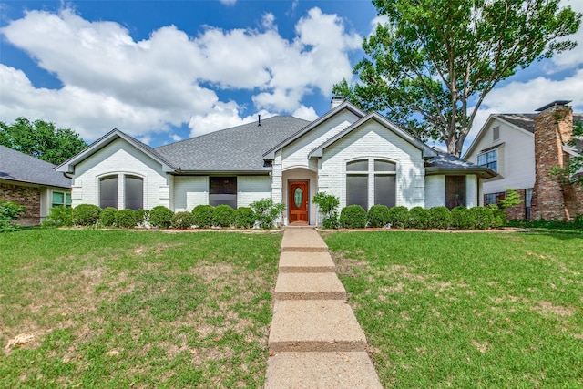 10220 Shadow Way, Dallas, TX 75243 - view of front of house with brick siding, a front yard, a chimney, and roof with shingles