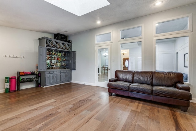 10220 Shadow Way, Dallas, TX 75243 - living room with a bar, wood finished floors, recessed lighting, and baseboards