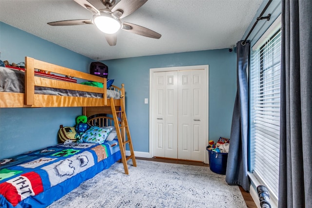 10220 Shadow Way, Dallas, TX 75243 - bedroom featuring a textured ceiling, ceiling fan, and a closet