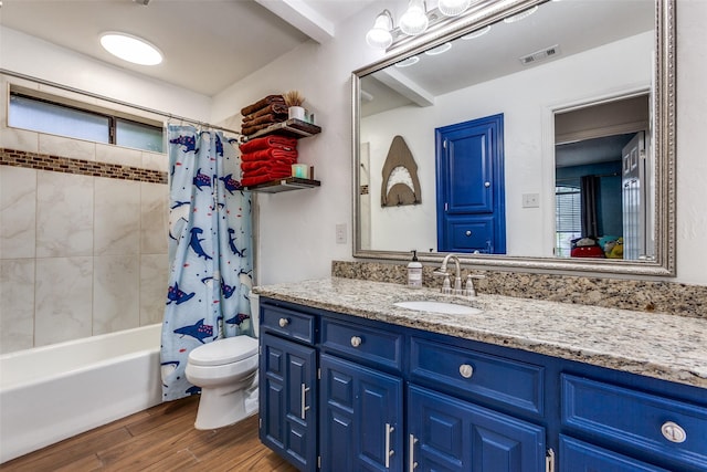 10220 Shadow Way, Dallas, TX 75243 - full bathroom featuring toilet, wood finished floors, vanity, and shower / tub combo
