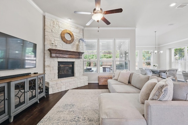 14513 Mediterranean Dr, Frisco, TX 75035 - living area featuring crown molding, dark wood-style flooring, a ceiling fan, a fireplace, and a chandelier