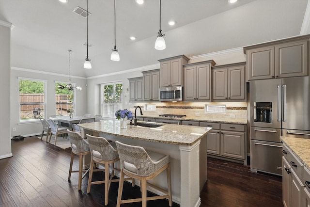 14513 Mediterranean Dr, Frisco, TX 75035 - kitchen featuring appliances with stainless steel finishes, gray cabinets, a sink, crown molding, and dark wood finished floors