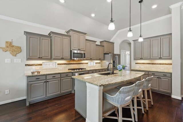 14513 Mediterranean Dr, Frisco, TX 75035 - kitchen with gray cabinets, a sink, appliances with stainless steel finishes, an island with sink, and ornamental molding
