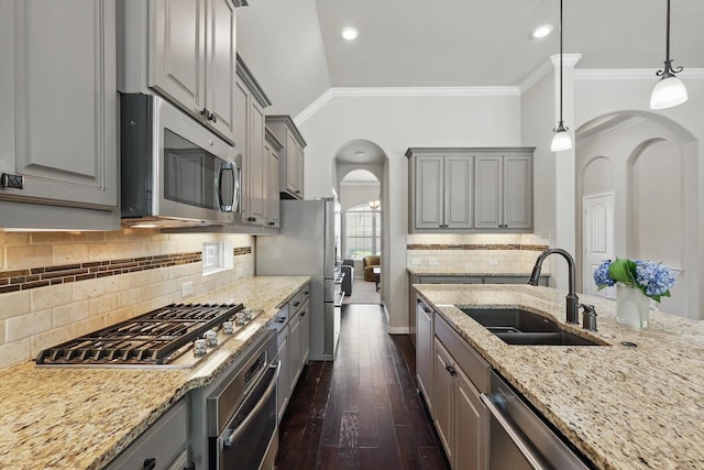 14513 Mediterranean Dr, Frisco, TX 75035 - kitchen featuring stainless steel appliances, gray cabinetry, a sink, arched walkways, and dark wood-style floors