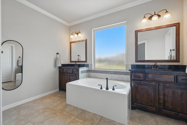 14513 Mediterranean Dr, Frisco, TX 75035 - bathroom featuring two vanities, a garden tub, crown molding, tile patterned floors, and baseboards