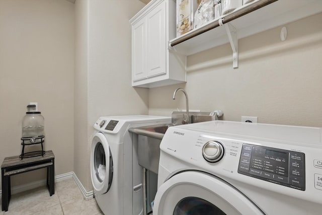 14513 Mediterranean Dr, Frisco, TX 75035 - washroom with separate washer and dryer, cabinet space, light tile patterned flooring, and baseboards