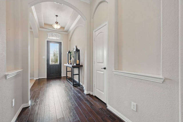 14513 Mediterranean Dr, Frisco, TX 75035 - entrance foyer with arched walkways, dark wood-type flooring, a raised ceiling, baseboards, and crown molding