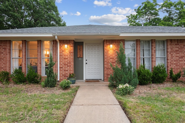 2512 Buckingham Dr, Denton, TX 76209 - doorway to property with brick siding and roof with shingles