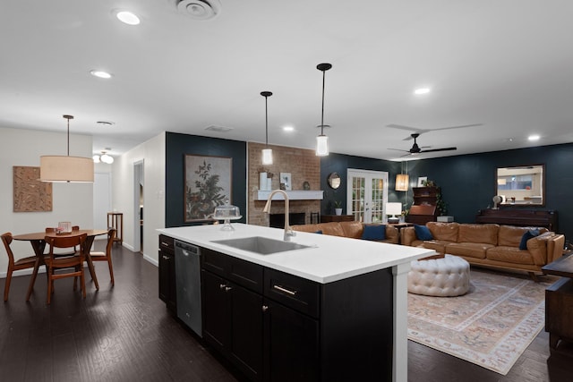 2512 Buckingham Dr, Denton, TX 76209 - kitchen featuring a sink, stainless steel dishwasher, dark cabinetry, light countertops, and recessed lighting