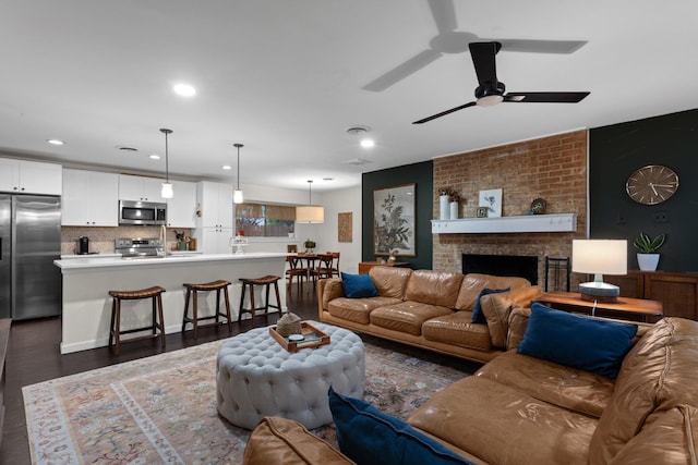 2512 Buckingham Dr, Denton, TX 76209 - living area featuring dark wood-style floors, ceiling fan, recessed lighting, and a brick fireplace