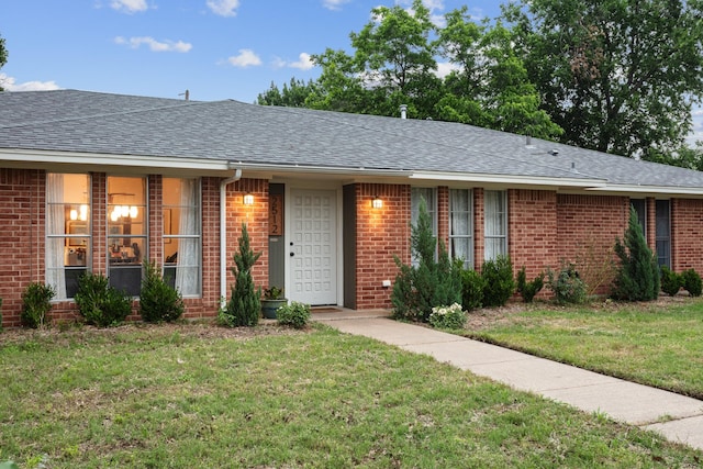 2512 Buckingham Dr, Denton, TX 76209 - single story home featuring roof with shingles, brick siding, and a front yard