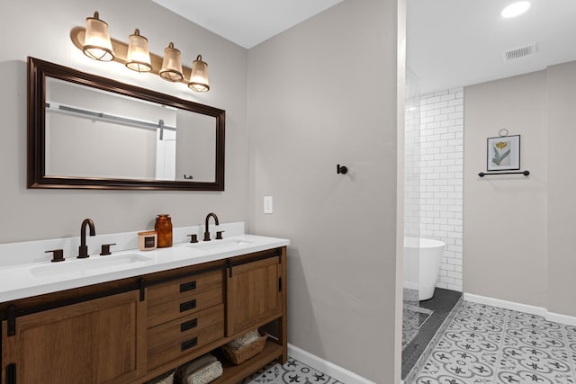 2512 Buckingham Dr, Denton, TX 76209 - full bathroom featuring double vanity, a freestanding tub, and baseboards