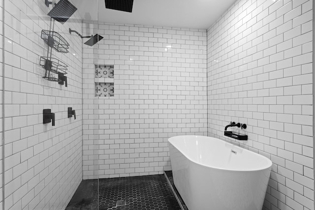 2512 Buckingham Dr, Denton, TX 76209 - bathroom featuring tile walls, a freestanding tub, and tiled shower