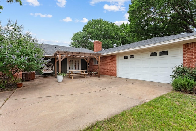 2512 Buckingham Dr, Denton, TX 76209 - view of front of home with french doors, a pergola, driveway, brick siding, and a chimney