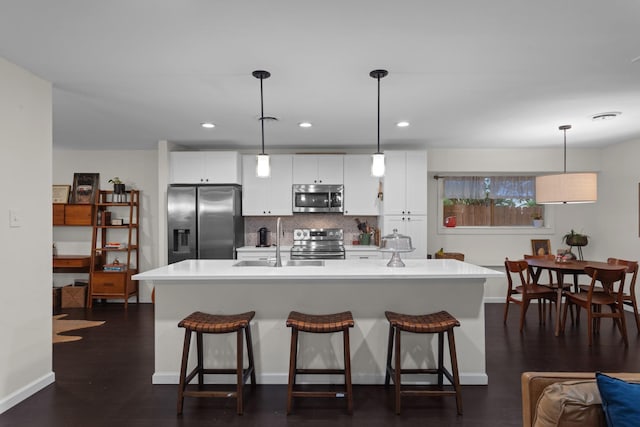 2512 Buckingham Dr, Denton, TX 76209 - kitchen with stainless steel appliances, a sink, backsplash, a kitchen bar, and a center island with sink