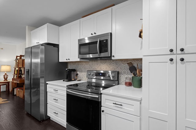 2512 Buckingham Dr, Denton, TX 76209 - kitchen with appliances with stainless steel finishes, light countertops, dark wood-style flooring, tasteful backsplash, and white cabinetry