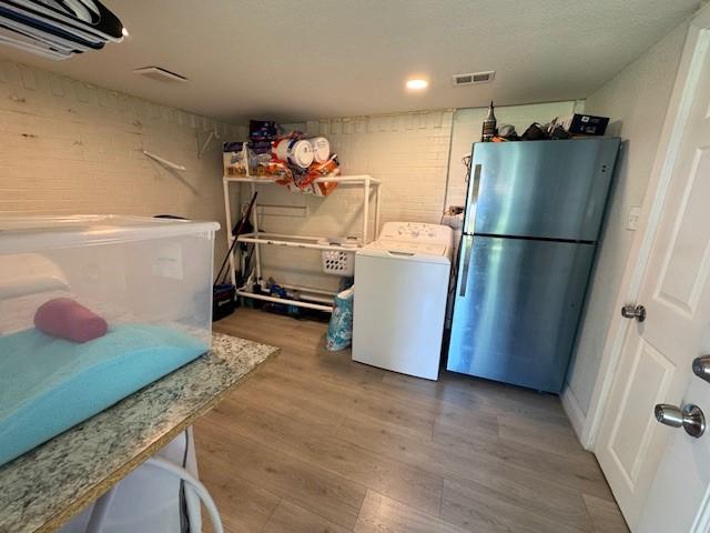 2711 San Diego Dr, Dallas, TX 75228 - washroom featuring washer / dryer and wood finished floors
