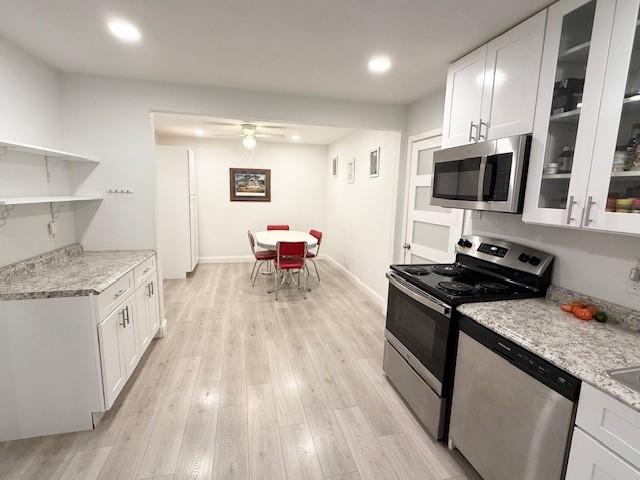 2711 San Diego Dr, Dallas, TX 75228 - kitchen featuring appliances with stainless steel finishes, white cabinetry, ceiling fan, light wood-type flooring, and recessed lighting