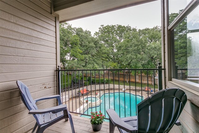 2313 Ember Woods Dr, Keller, TX 76262 - balcony featuring a pool with connected hot tub, view of pool, and view of scattered trees