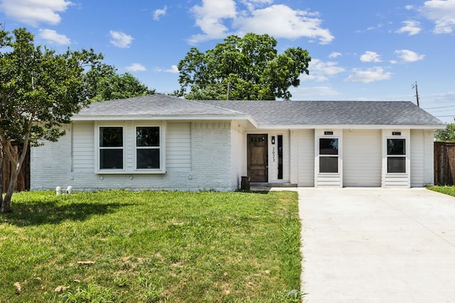 2023 William Ln, Carrollton, TX 75006 - single story home featuring driveway, brick siding, and roof with shingles
