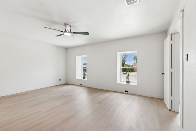 2023 William Ln, Carrollton, TX 75006 - unfurnished room with light wood-style floors, ceiling fan, and baseboards
