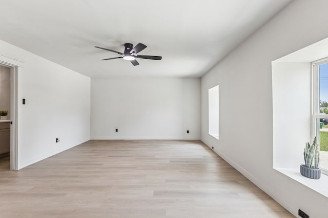 2023 William Ln, Carrollton, TX 75006 - empty room with healthy amount of natural light, a ceiling fan, light wood-style floors, and baseboards