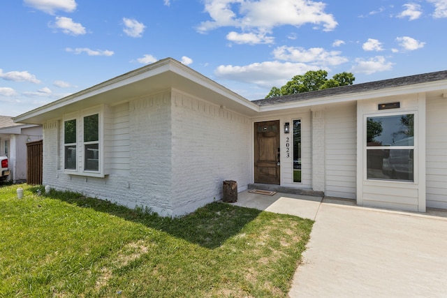 2023 William Ln, Carrollton, TX 75006 - entrance to property featuring brick siding and a lawn