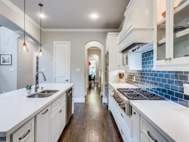 916 Shadyside Ln, Dallas, TX 75223 - kitchen featuring a sink, appliances with stainless steel finishes, premium range hood, arched walkways, and white cabinets