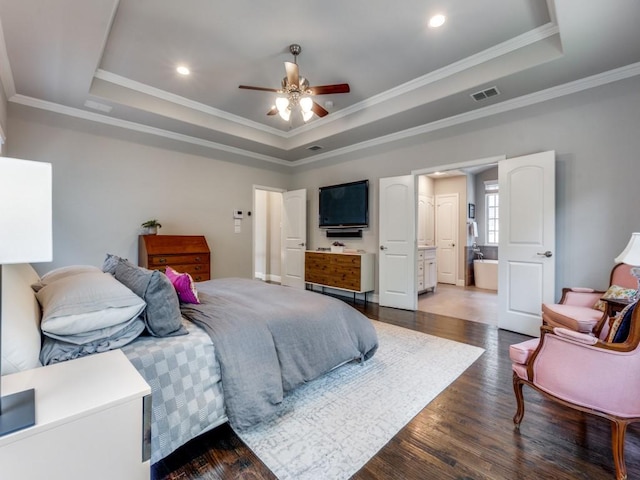 916 Shadyside Ln, Dallas, TX 75223 - bedroom with a raised ceiling, dark wood-style flooring, crown molding, recessed lighting, and connected bathroom