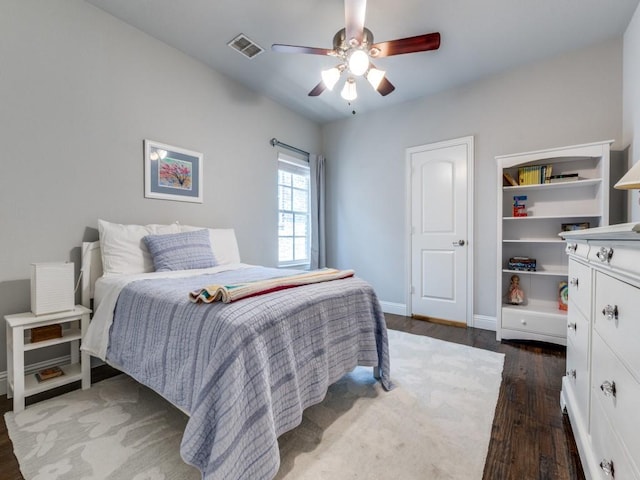 916 Shadyside Ln, Dallas, TX 75223 - bedroom with dark wood-style flooring, baseboards, and a ceiling fan