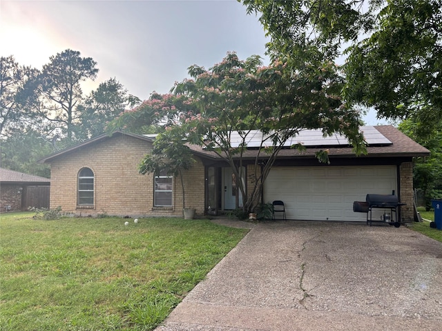 3704 Northpark Dr, Corsicana, TX 75110 - ranch-style home featuring brick siding, solar panels, a garage, and driveway