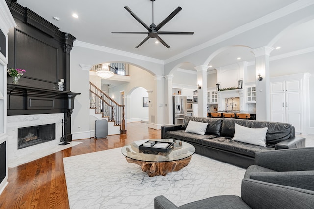 13 Kensington Dr, Heath, TX 75032 - living area featuring ceiling fan, wood finished floors, ornate columns, recessed lighting, and a premium fireplace