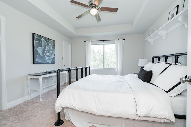 13 Kensington Dr, Heath, TX 75032 - carpeted bedroom featuring a raised ceiling, baseboards, and ceiling fan